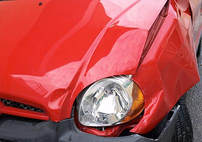Crumpled wing of a small car after an accident